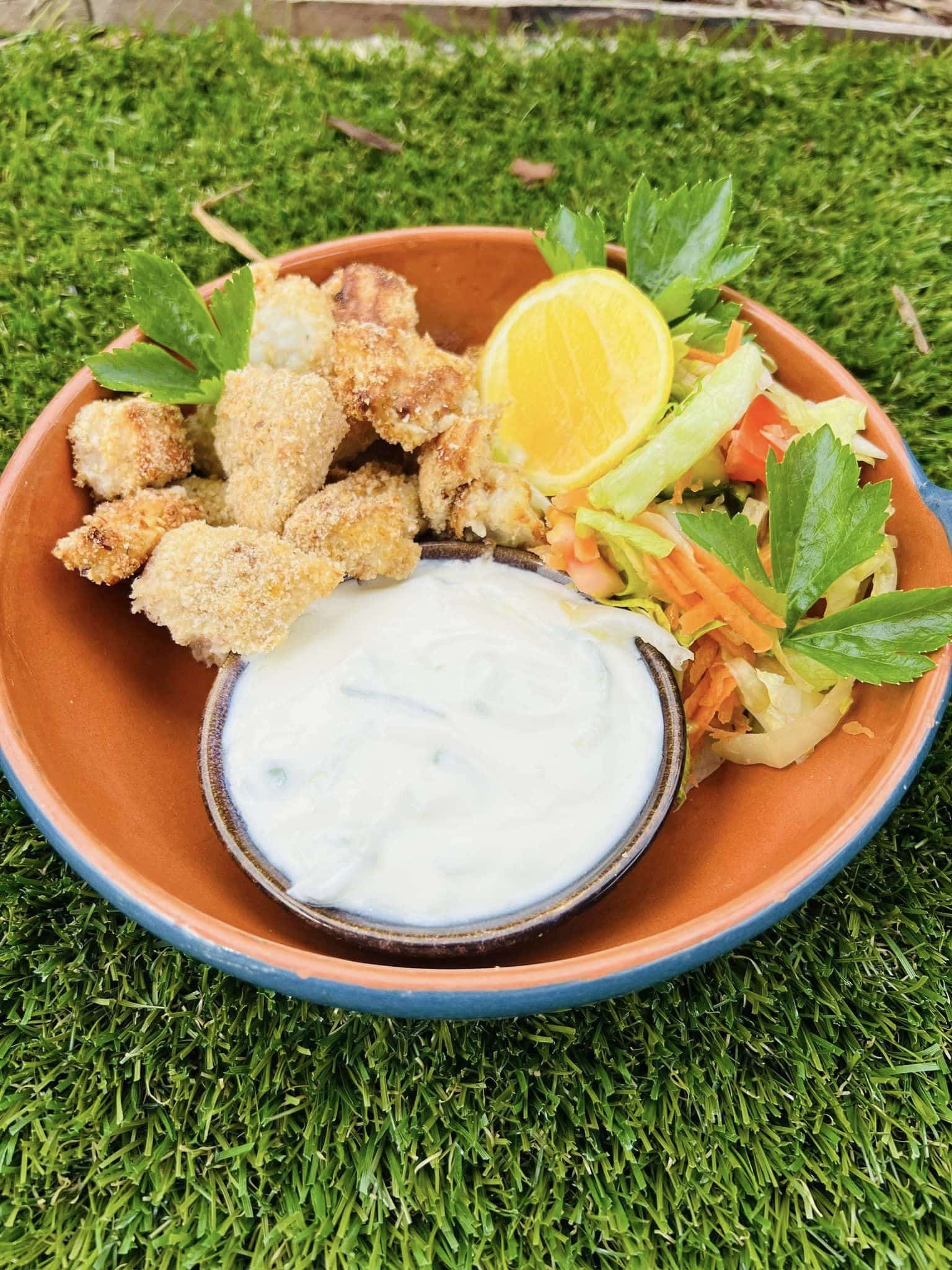 Crumbed fish bites with tzatziki and fresh salad