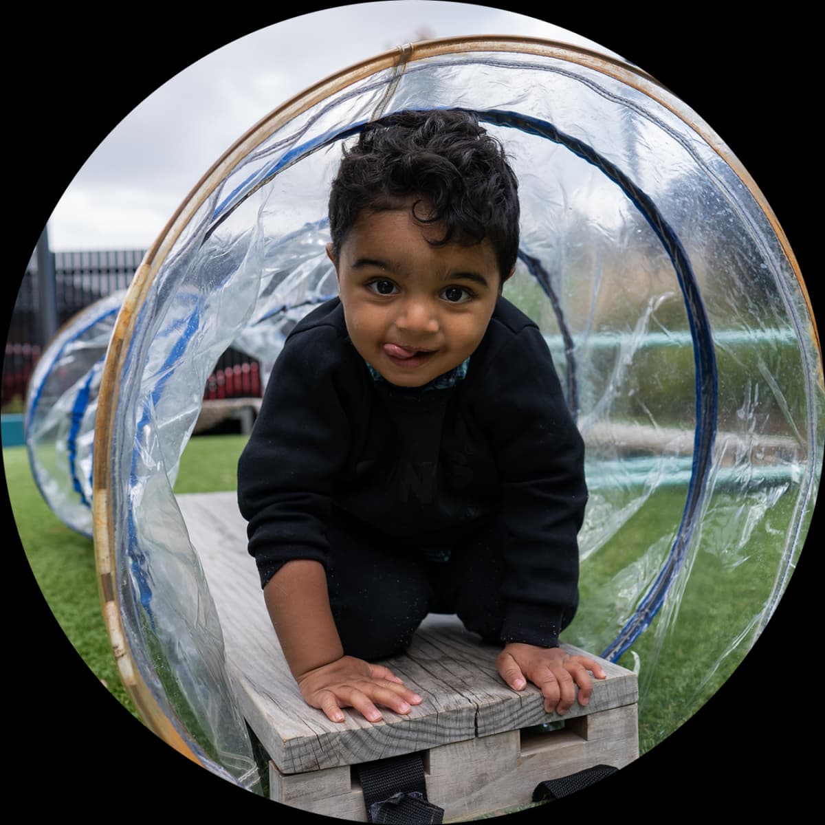 Young child exploring a play tunnel