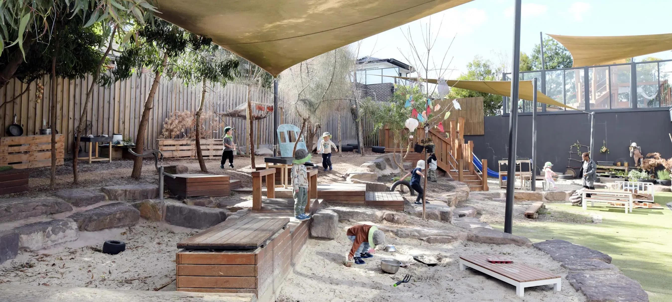 Children playing in a natural outdoor learning environment at an Explorers centre