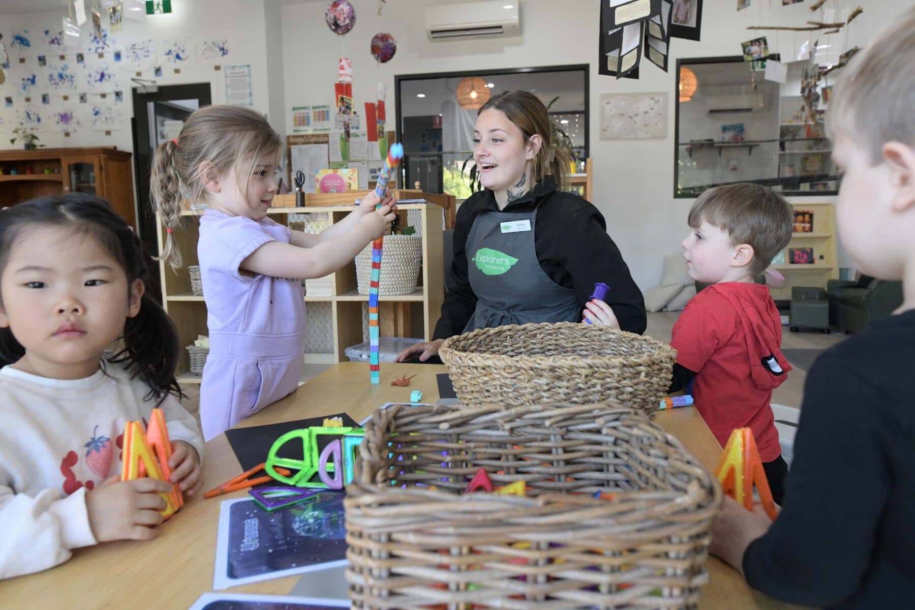 Educator with children inside an Explorers centre