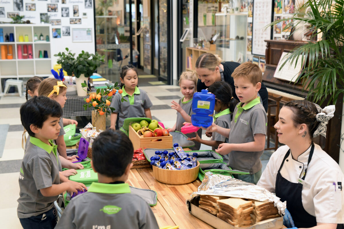 children and educators packing lunchboxes