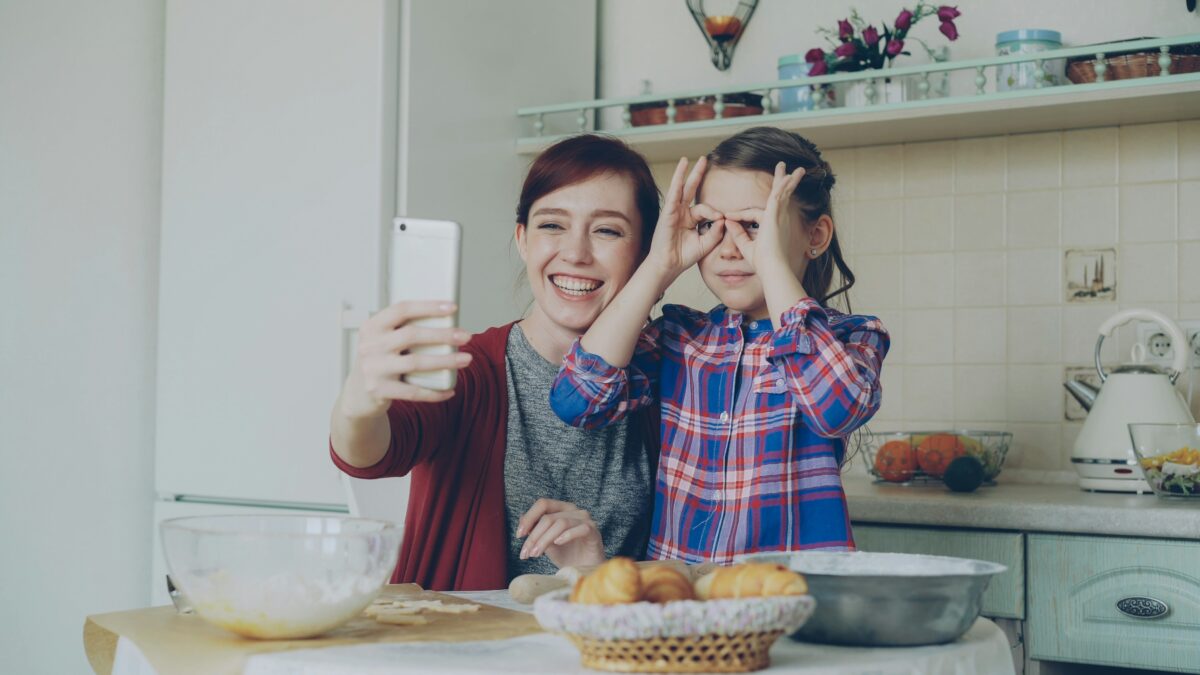 Child and parent social media taking a photo