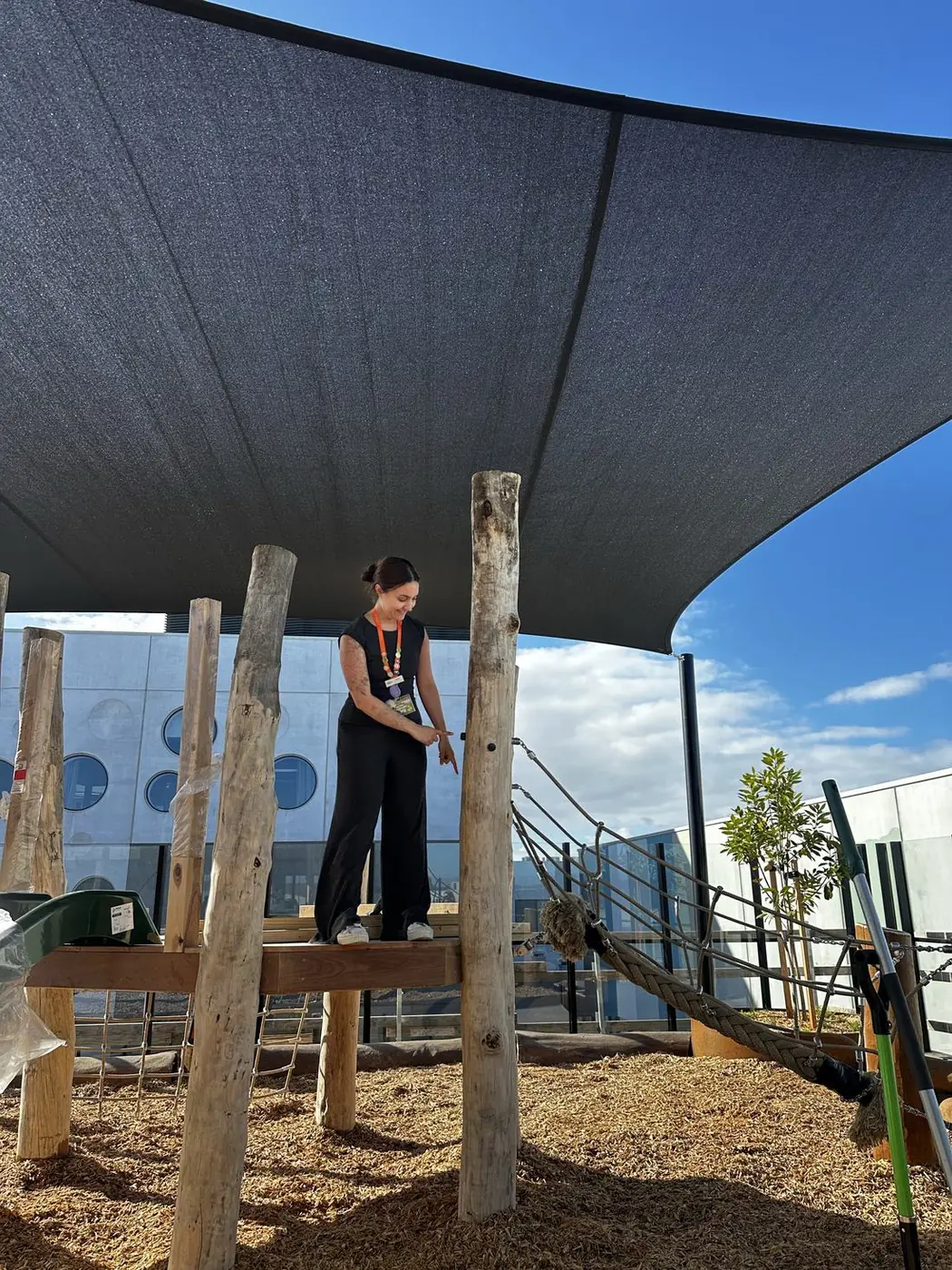 Educator standing on the elevated timber platform explaining the outdoor design